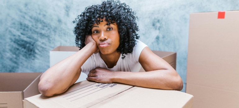 a girl leaning on the box
