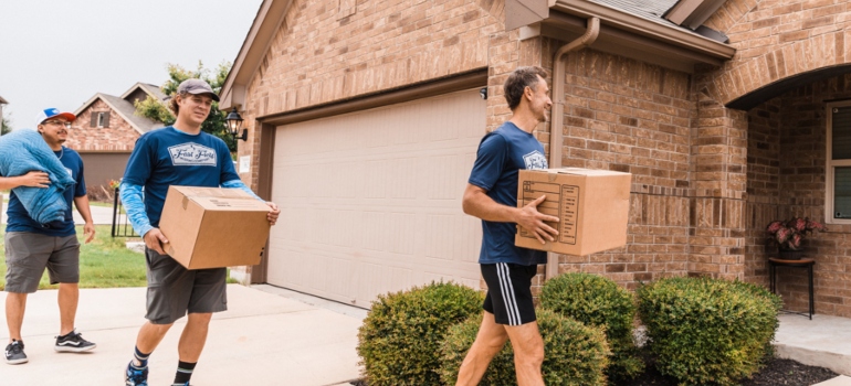 three movers with boxes